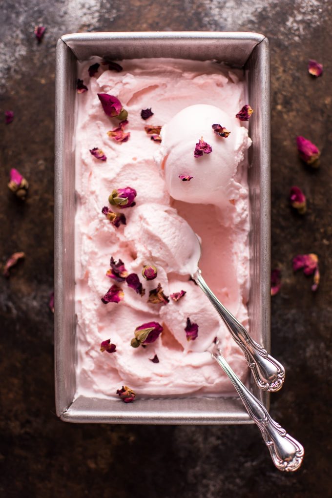 metal container with rose ice cream and a spoon