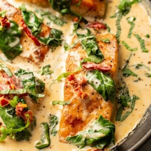 a skillet with creamy tuscan salmon