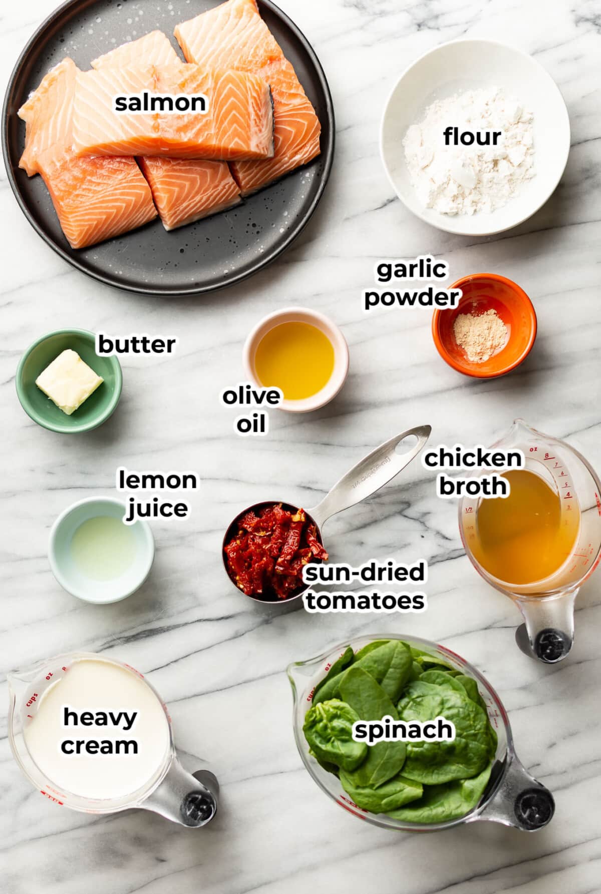 ingredients for creamy tuscan salmon in prep bowls