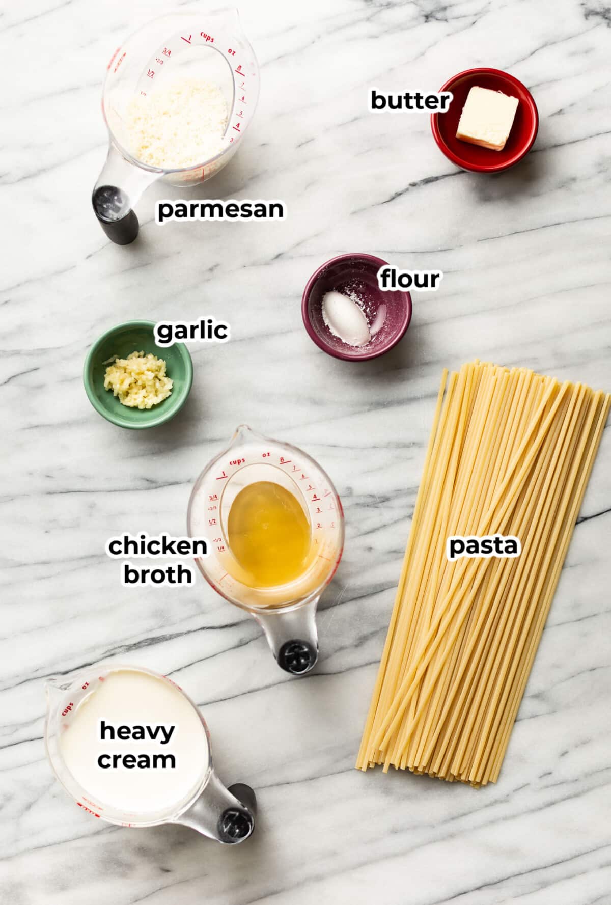 ingredients for creamy garlic pasta in prep bowls