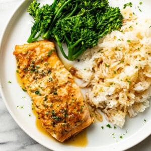 a plate with honey garlic salmon, rice, and broccolini