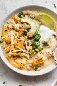 This easy white chicken chili recipe is rapid and delicious. It's so creamy and flavorful that everyone will want moments! Top it with your favorites including tortilla strips, avocado, lime, scallions, and cilantro.