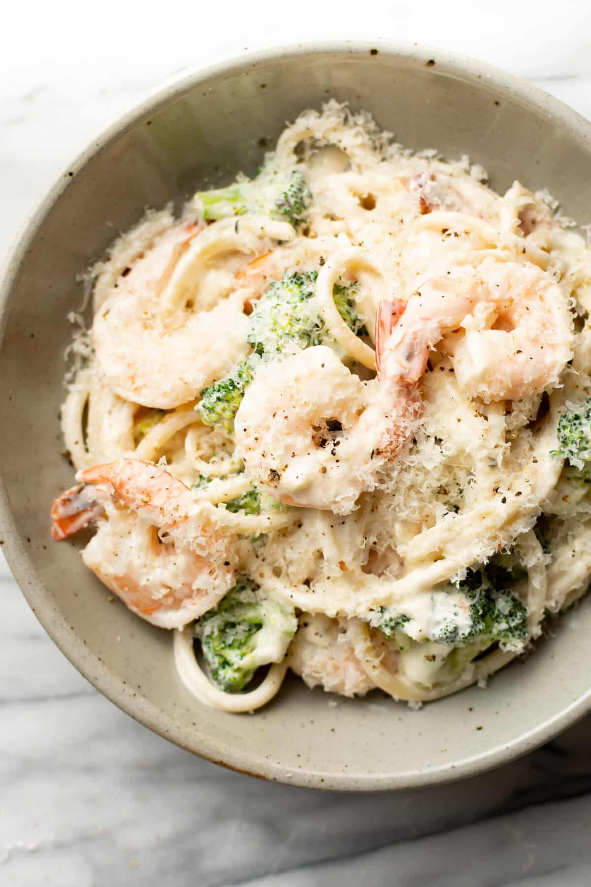 a bowl of creamy shrimp and broccoli pasta