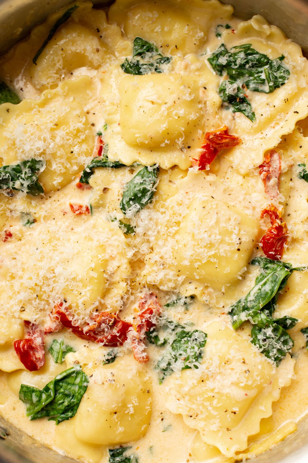 closeup of a skillet with creamy tuscan ravioli