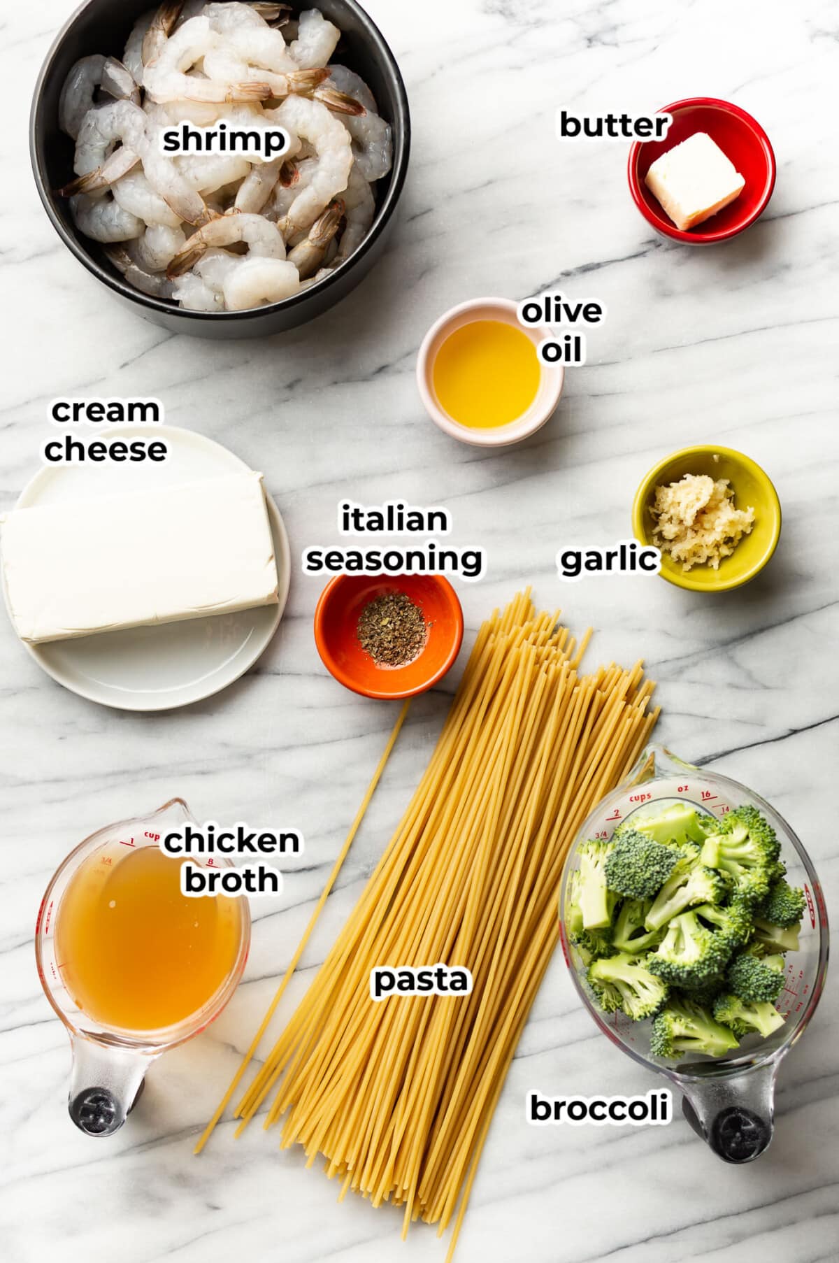 ingredients for creamy shrimp and broccoli pasta in prep bowls