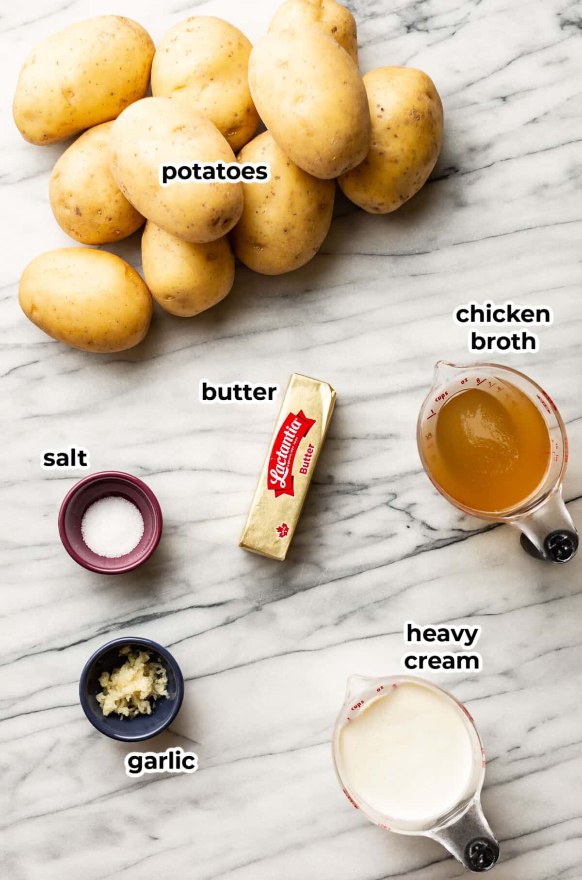 ingredients for crockpot mashed potatoes on a marble counter