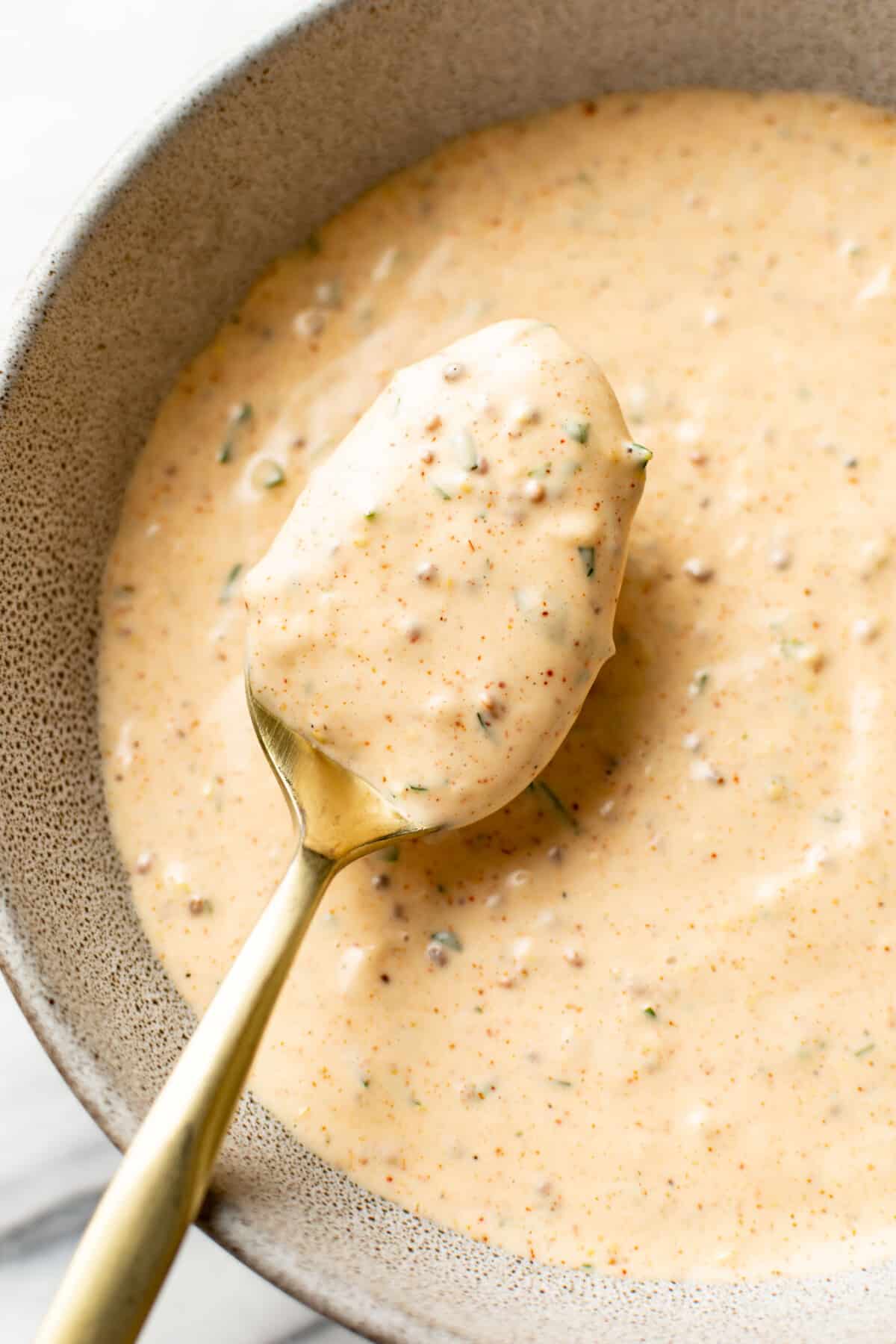 a bowl of remoulade sauce with a spoon