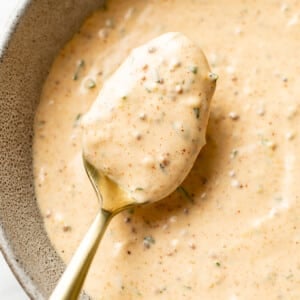 a bowl of remoulade sauce with a spoon