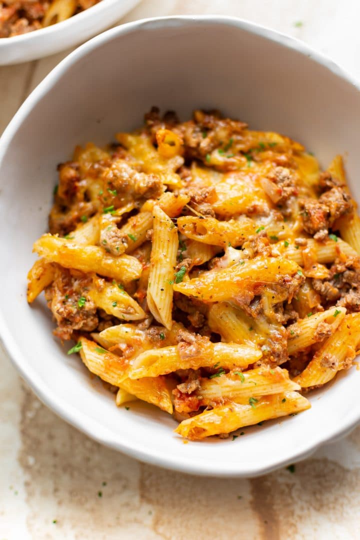 pasta bake with ground beef in a white bowl