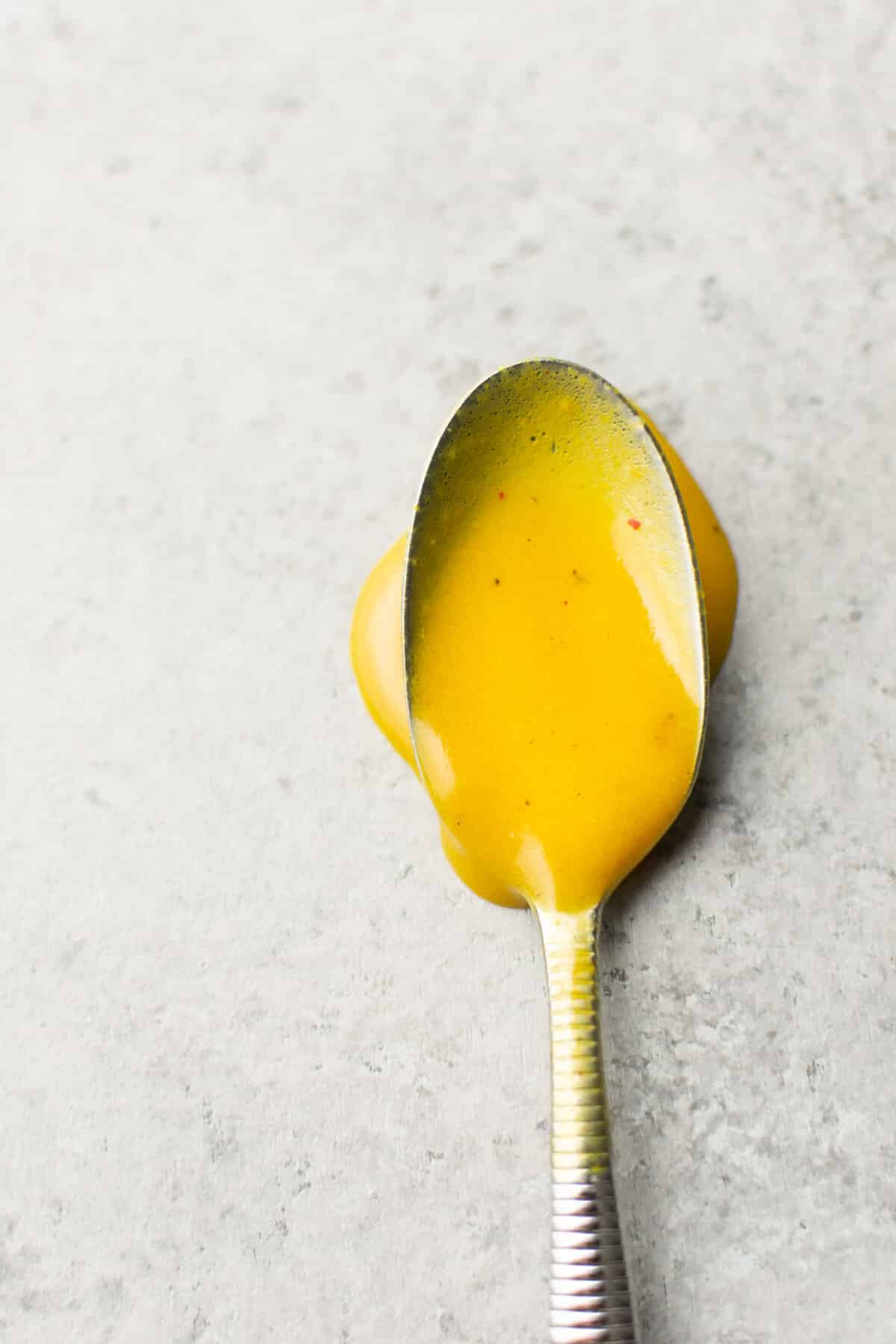 a spoon with homemade honey mustard dressing