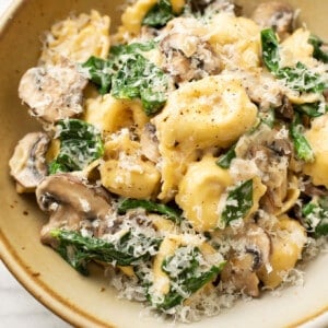 a bowl with spinach mushroom tortellini