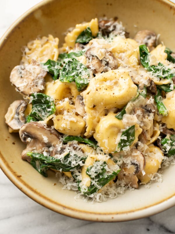 a bowl with spinach mushroom tortellini