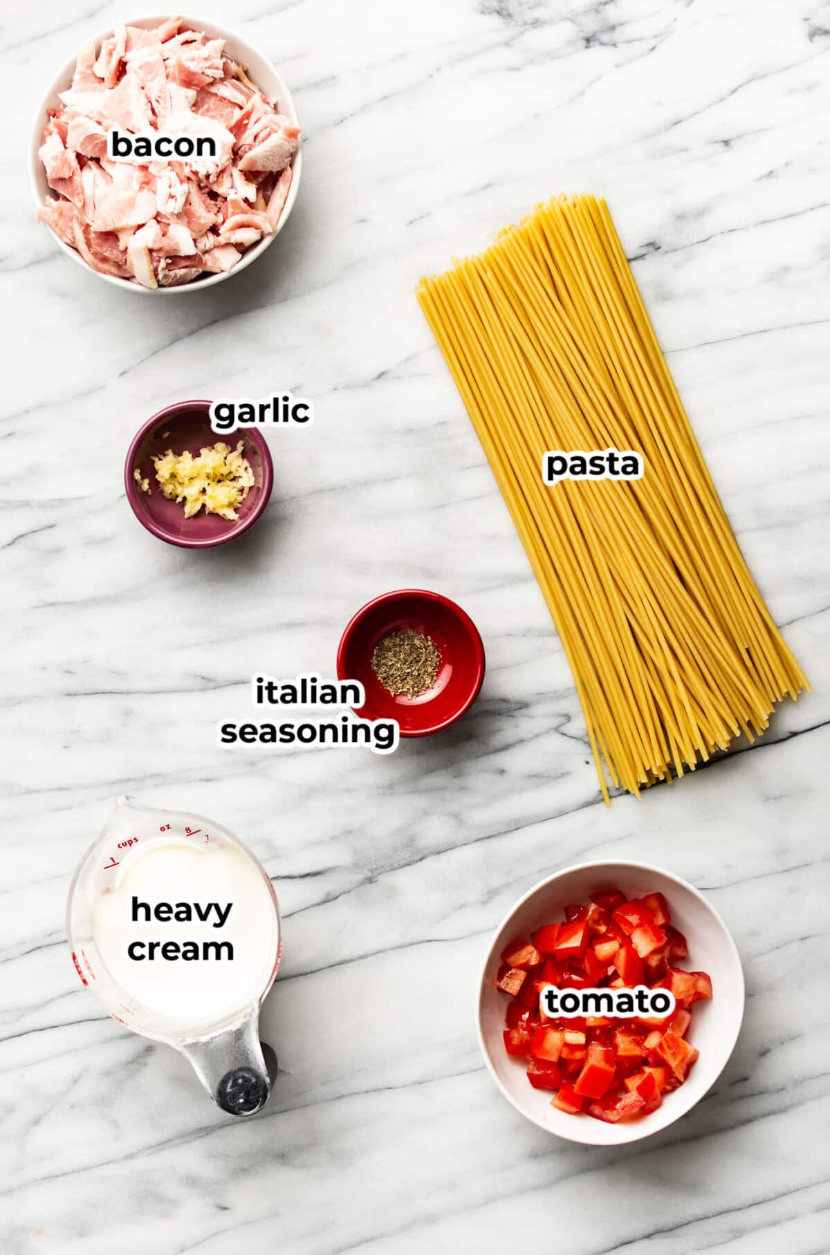 ingredients for creamy bacon and tomato pasta in prep bowls