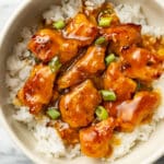 homemade orange chicken over rice in a bowl