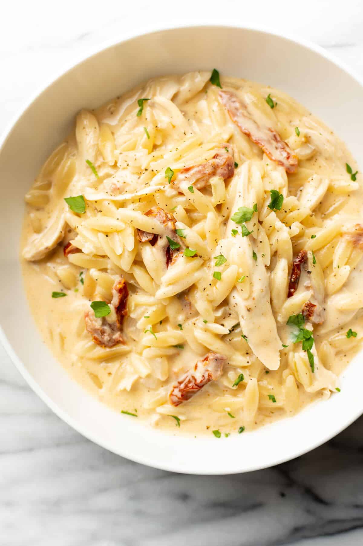 a bowl with cajun chicken orzo