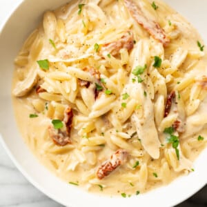 a bowl with cajun chicken orzo