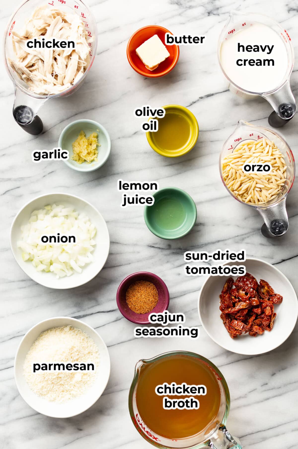 ingredients for cajun chicken orzo in prep bowls