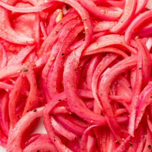 closeup of several slices of pickled red onions