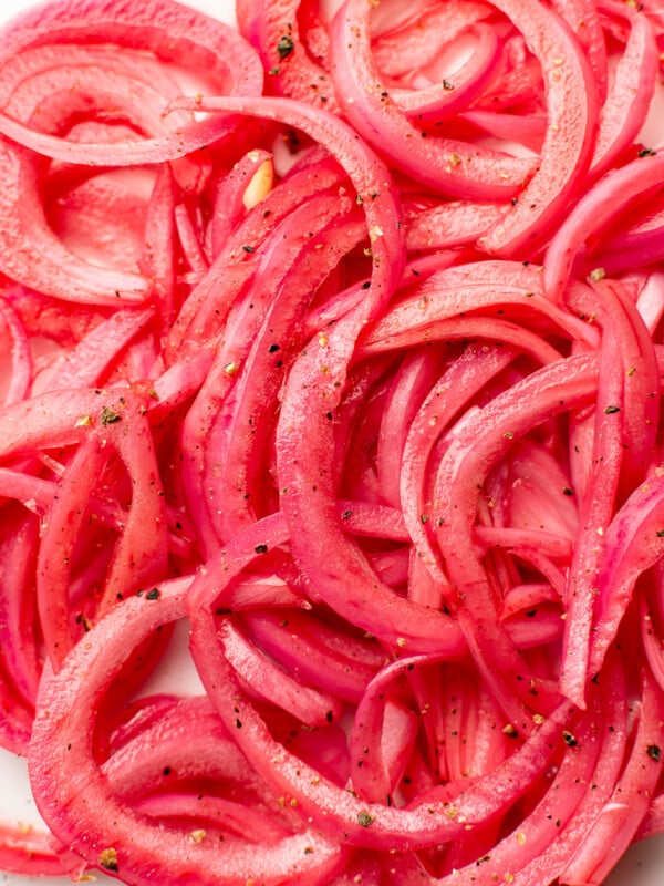 closeup of several slices of pickled red onions
