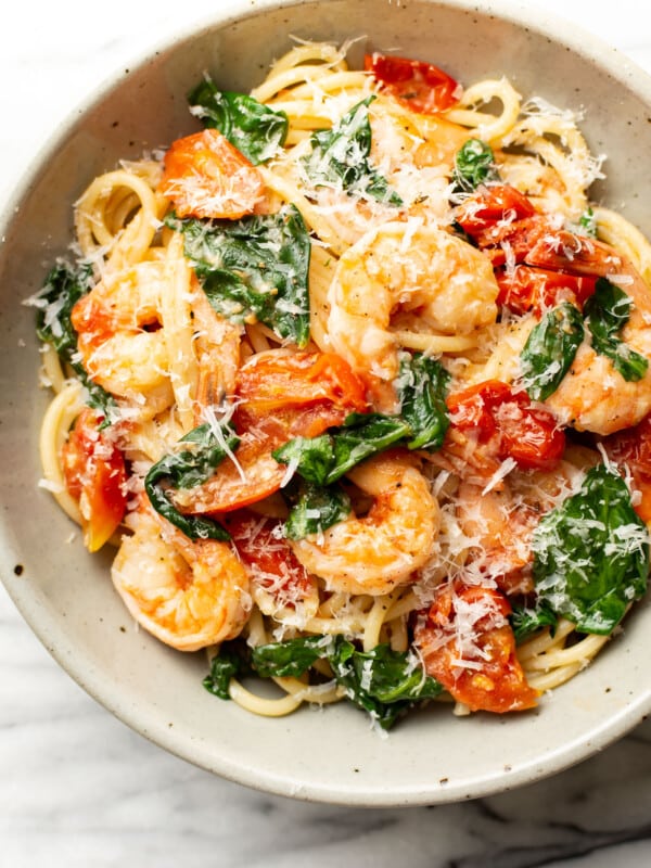 a bowl of tomato spinach shrimp pasta