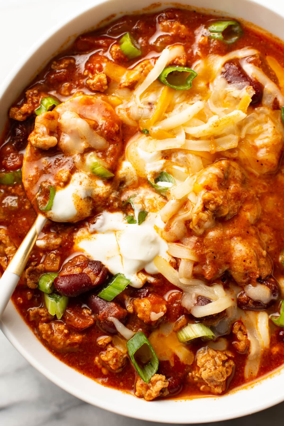 a bowl of turkey chili with a spoon