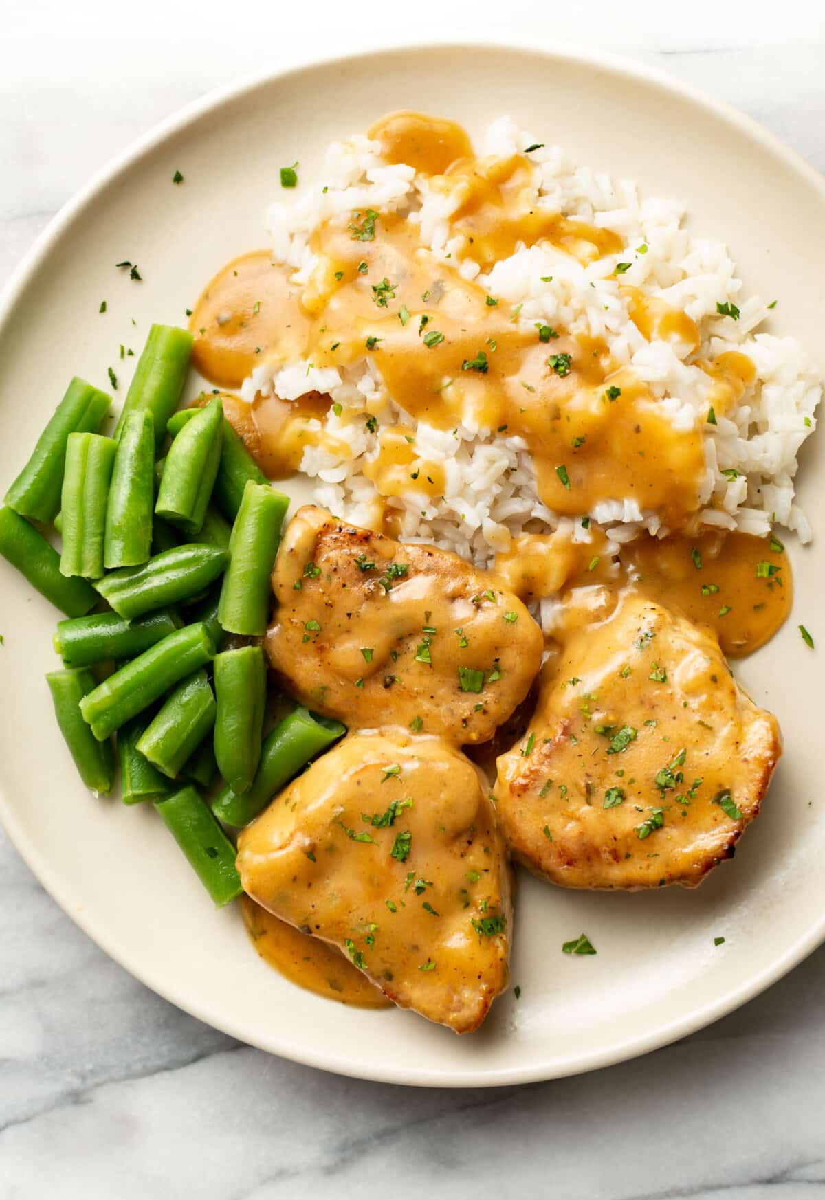 a plate with ranch pork tenderloin, rice, and green beans