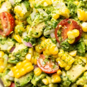 closeup of a bowl of corn salad with avocado