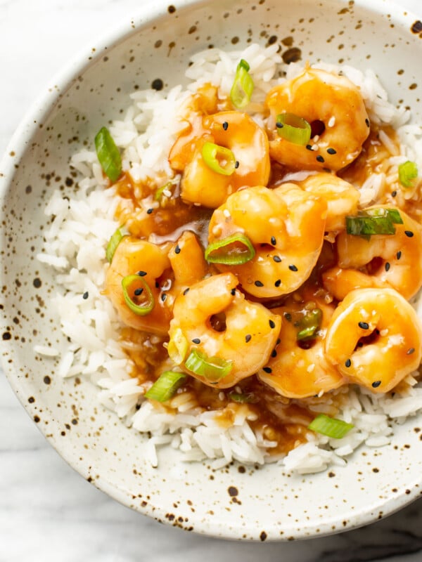 a bowl of honey garlic shrimp over rice