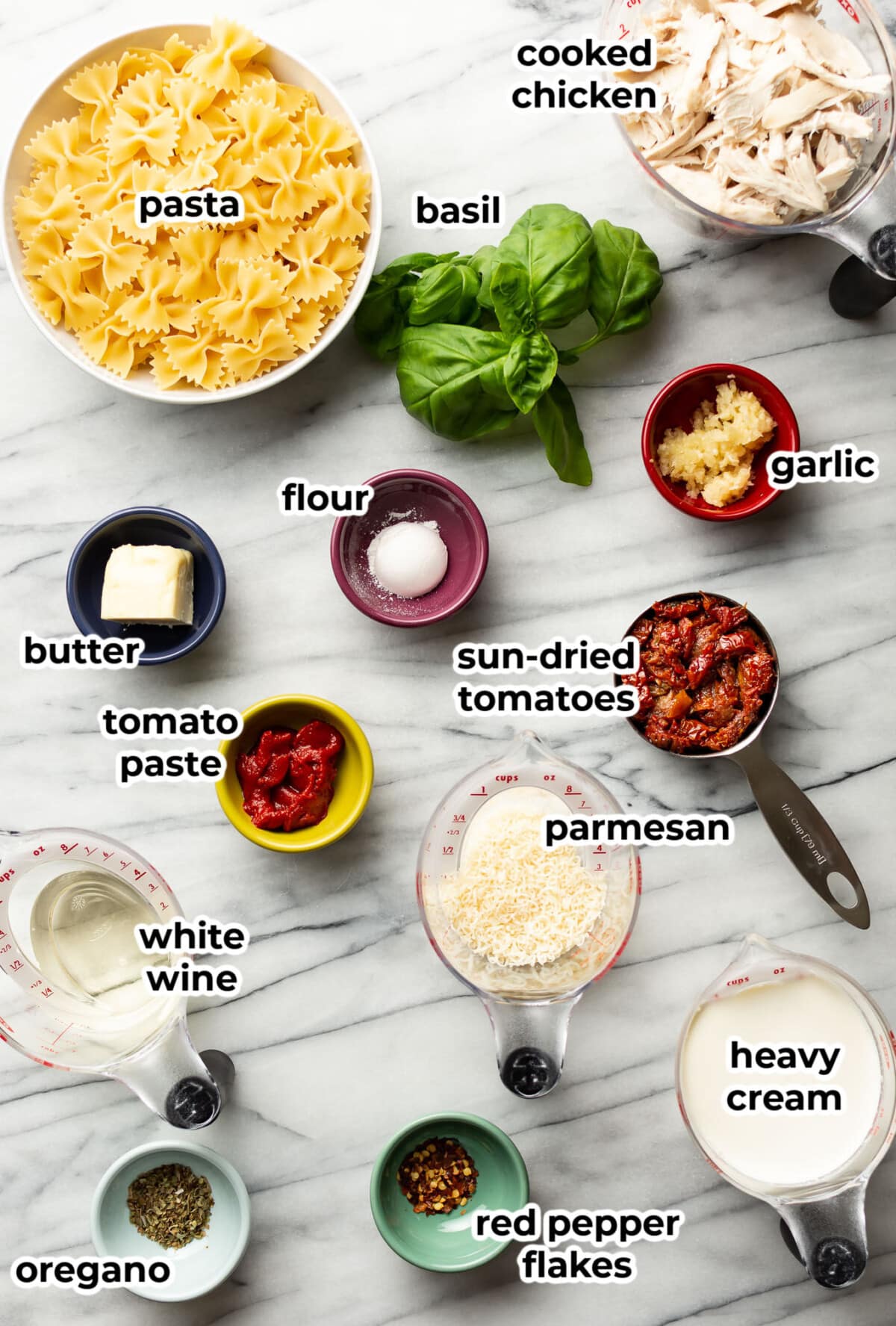 ingredients for marry me chicken pasta in prep bowls