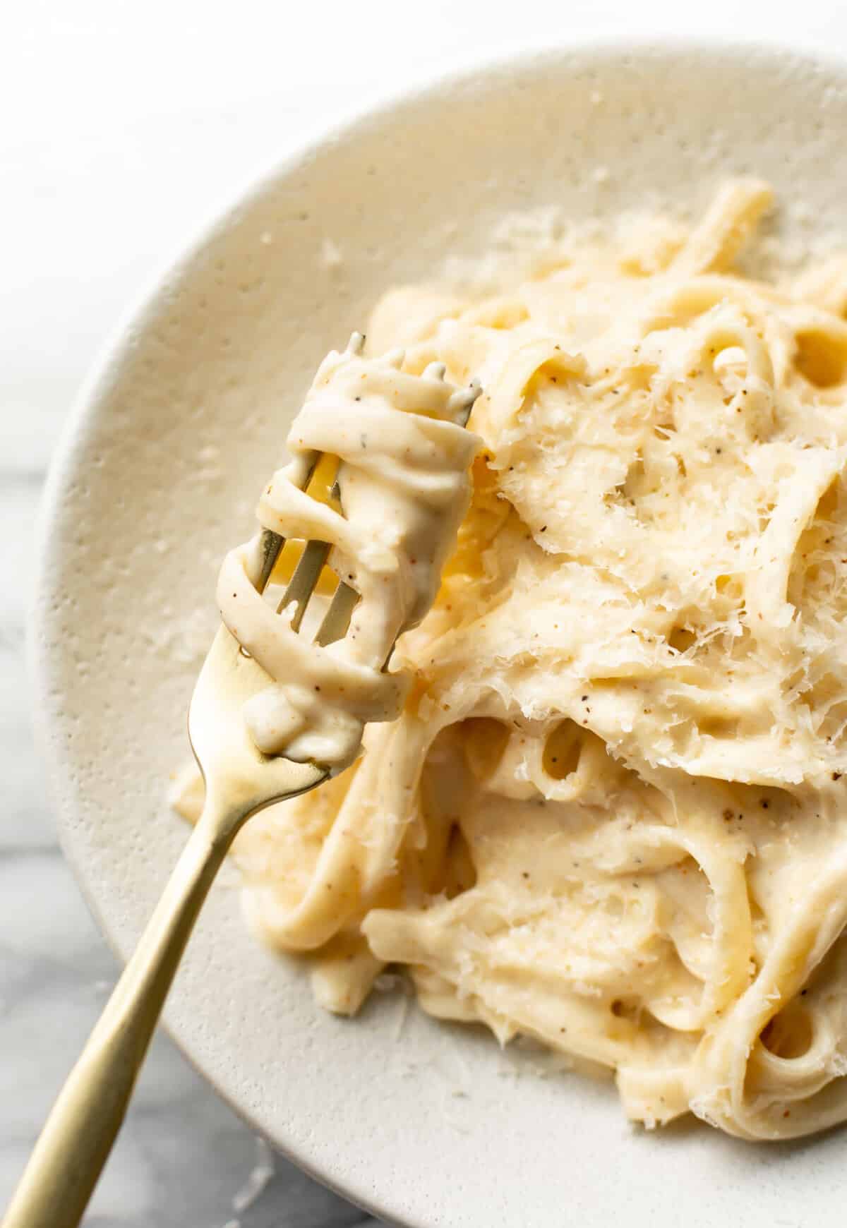 a bowl of cajun fettuccine alfredo with a fork