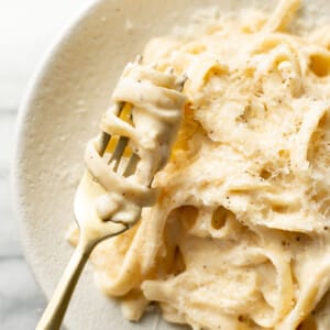 a bowl of cajun fettuccine alfredo with a fork