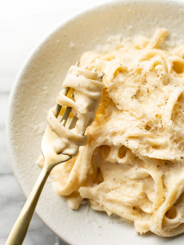 a bowl of cajun fettuccine alfredo with a fork