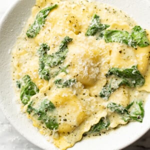 a bowl of creamy pesto ravioli