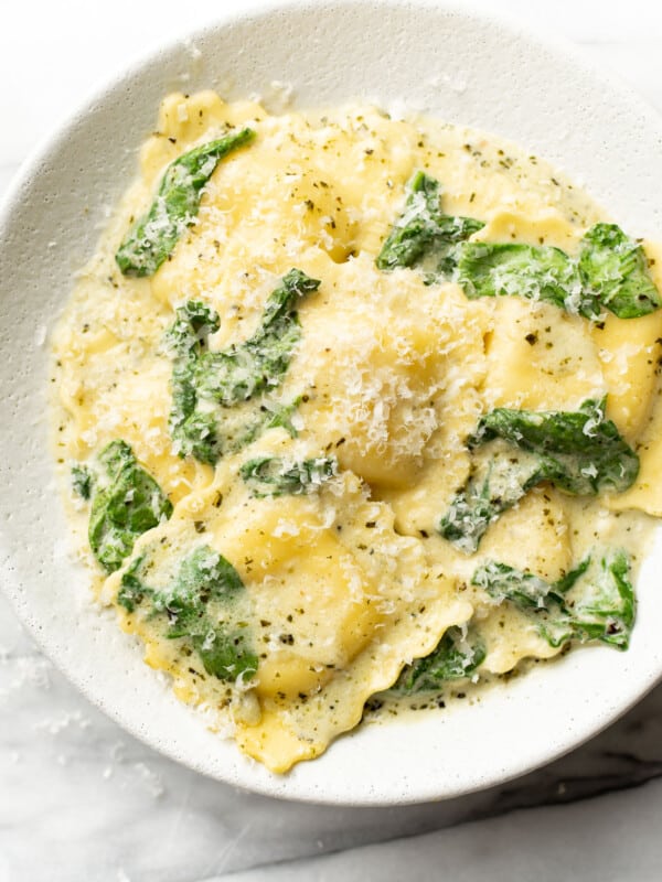 a bowl of creamy pesto ravioli