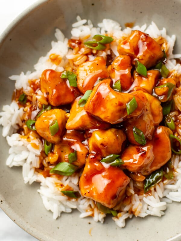 a bowl of firecracker chicken over rice