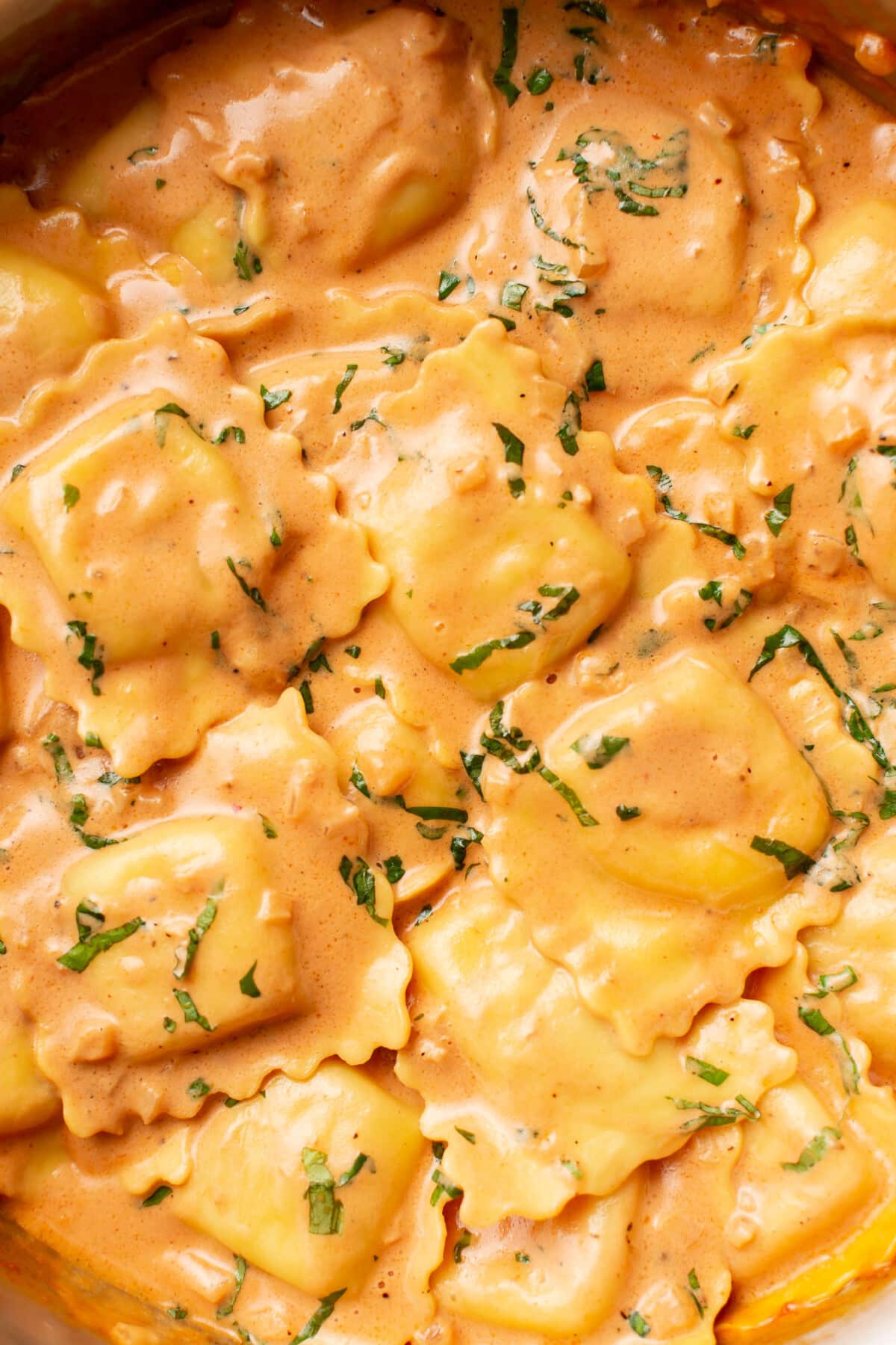 closeup of a skillet with ravioli and vodka sauce