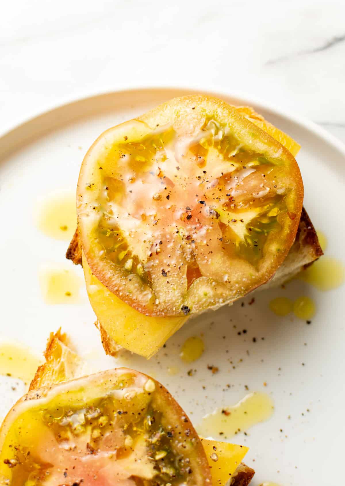 a plate with an heirloom tomato sandwich