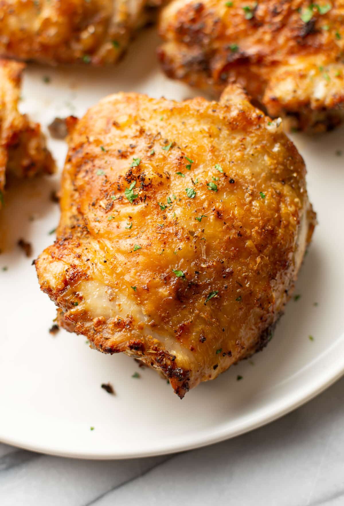 closeup of crispy air fryer chicken thighs on a plate