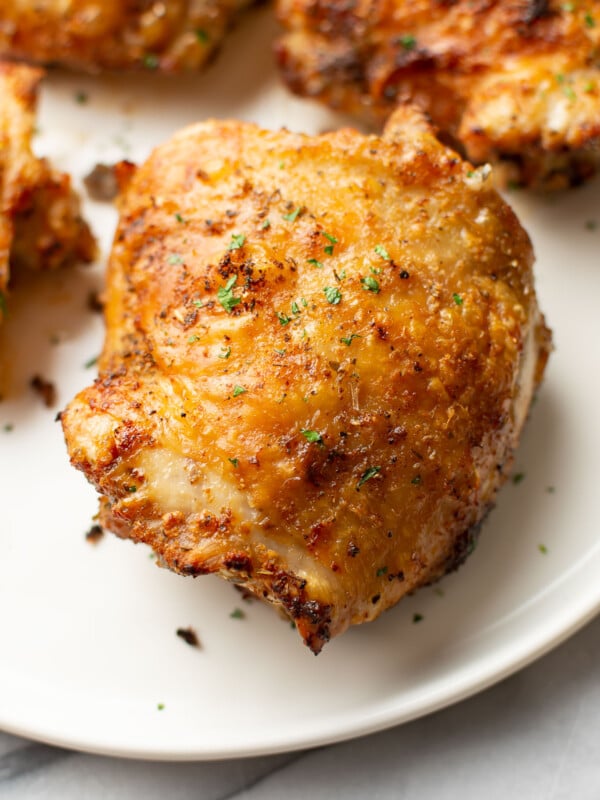 closeup of crispy air fryer chicken thighs on a plate