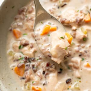 a bowl of chicken and wild rice soup with a spoon