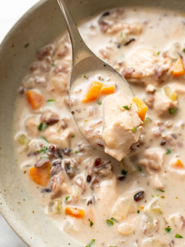 a bowl of chicken and wild rice soup with a spoon