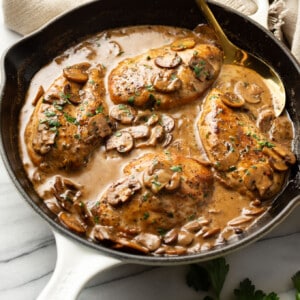 a skillet with balsamic chicken and a serving spoon