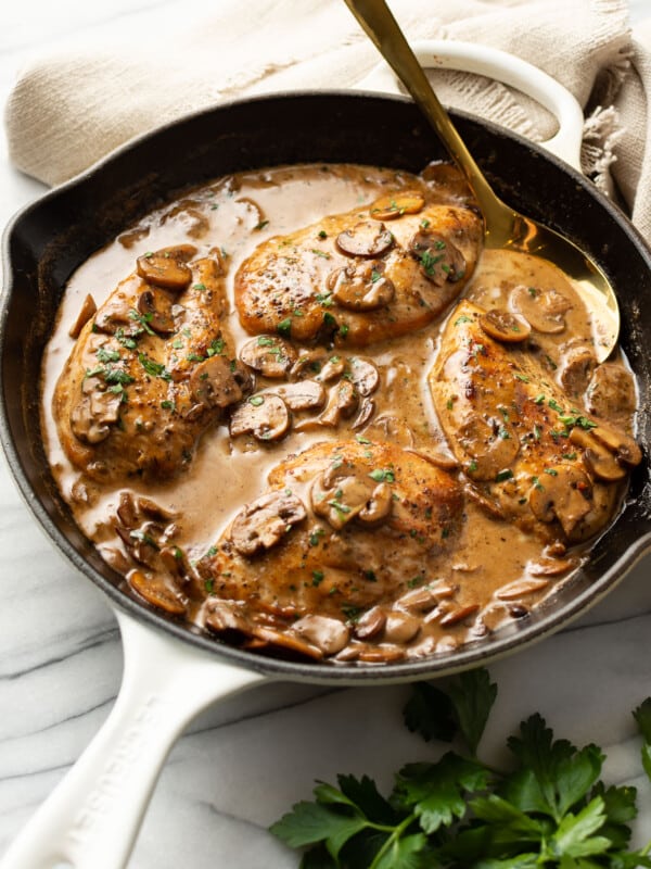 a skillet with balsamic chicken and a serving spoon