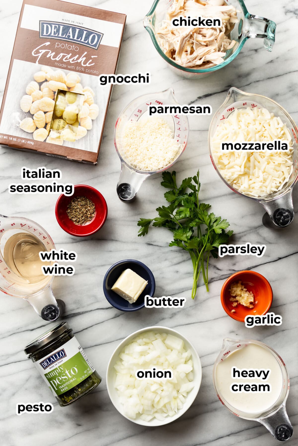 ingredients for pesto chicken gnocchi bake in prep bowls