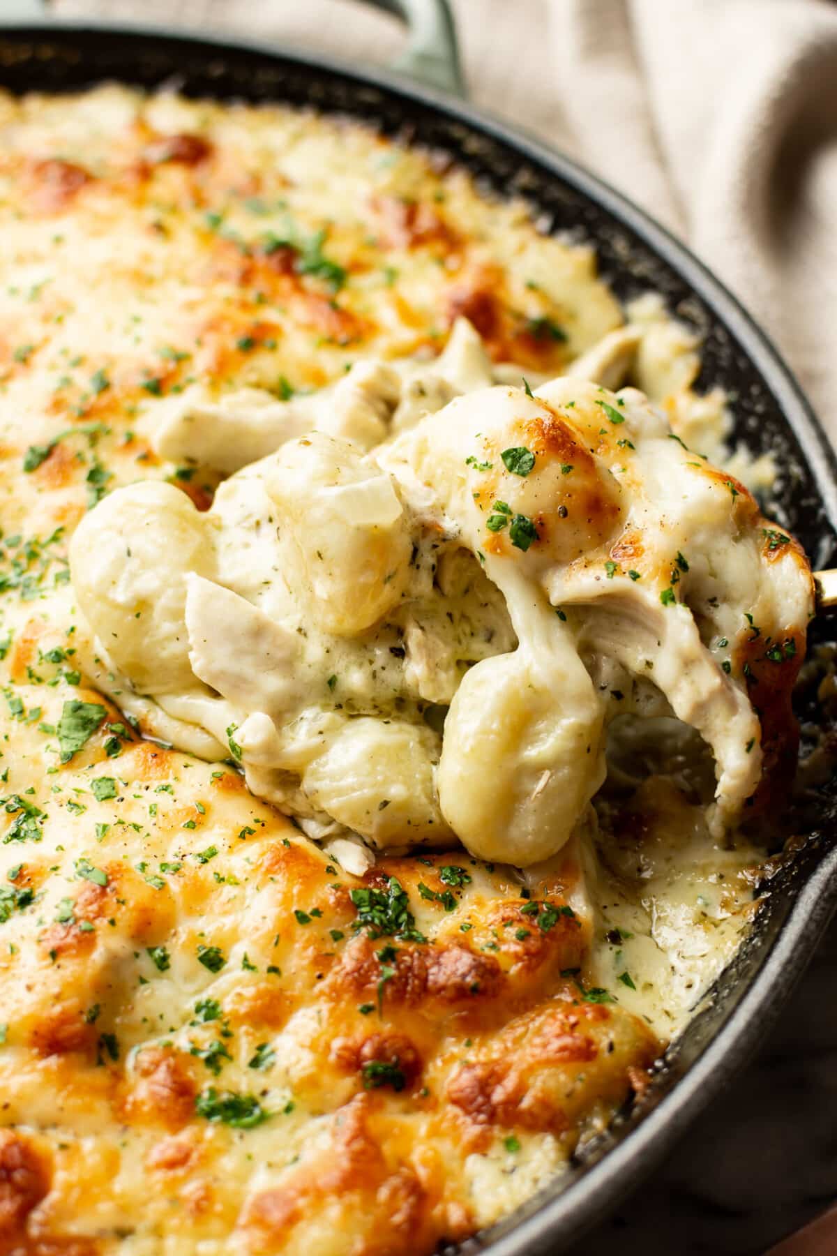 closeup of a skillet with pesto chicken gnocchi