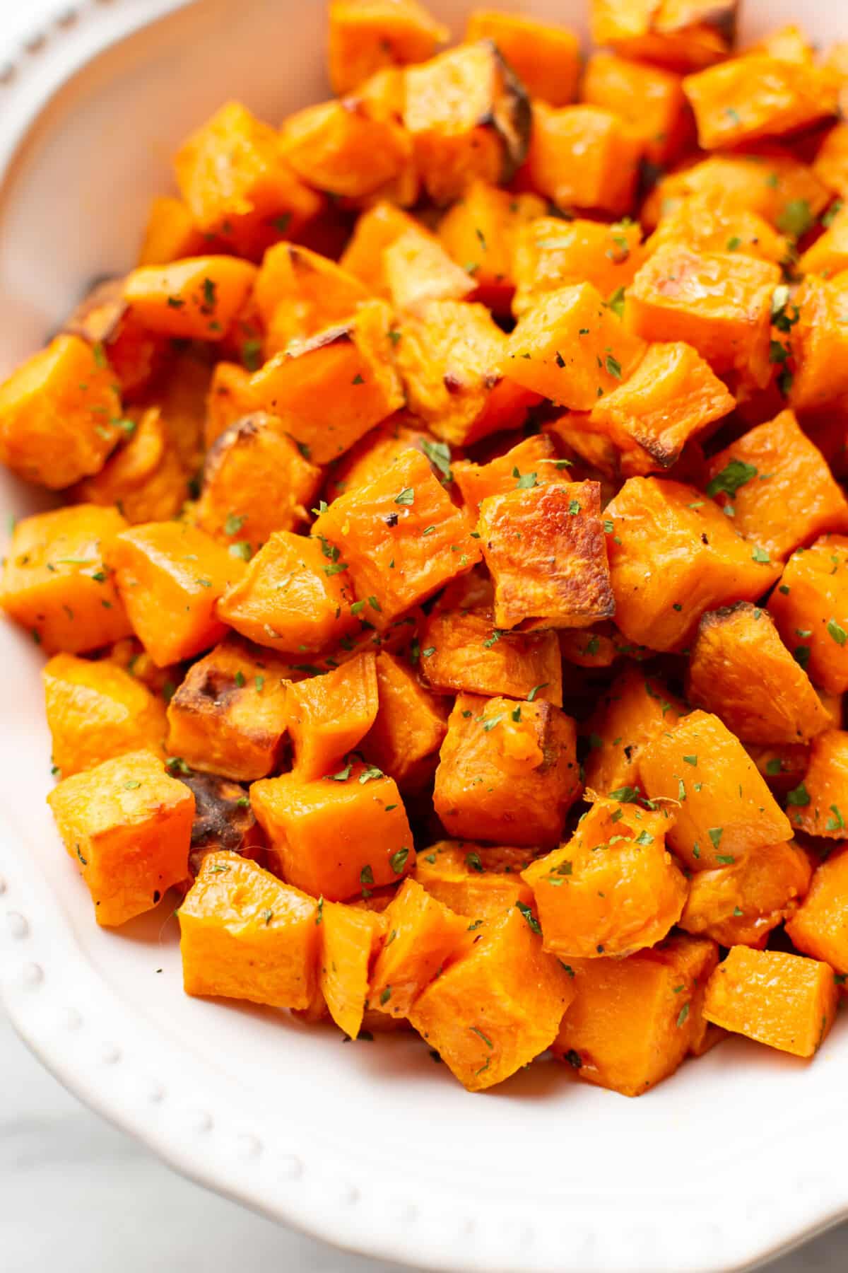 a bowl of diced roasted sweet potatoes