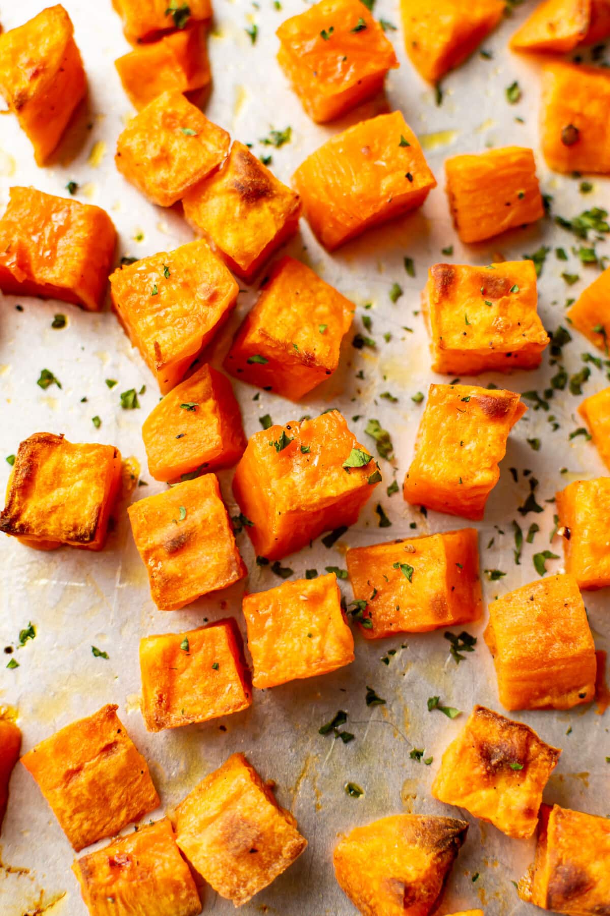 closeup of a baking sheet with roasted sweet potatoes