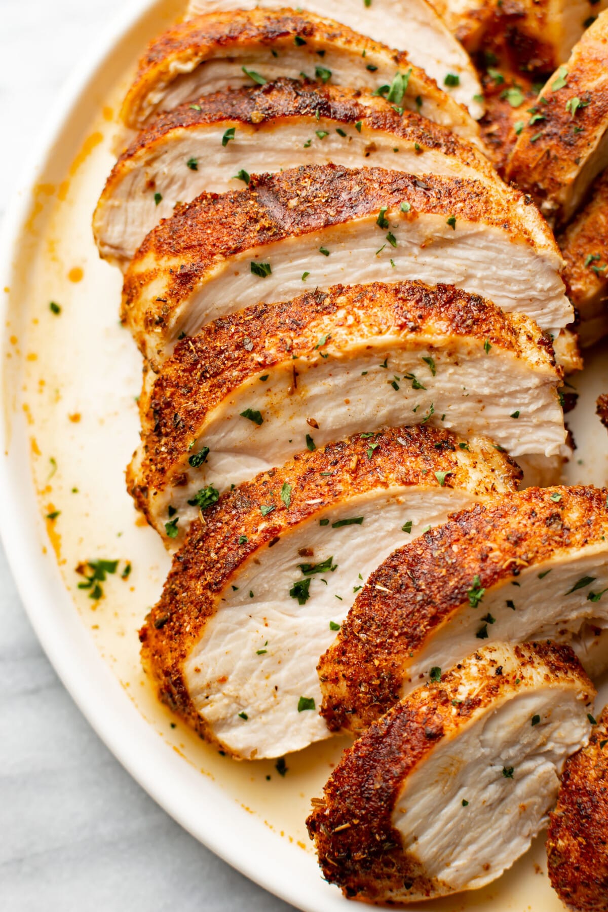 a plate with sliced air fryer chicken breast