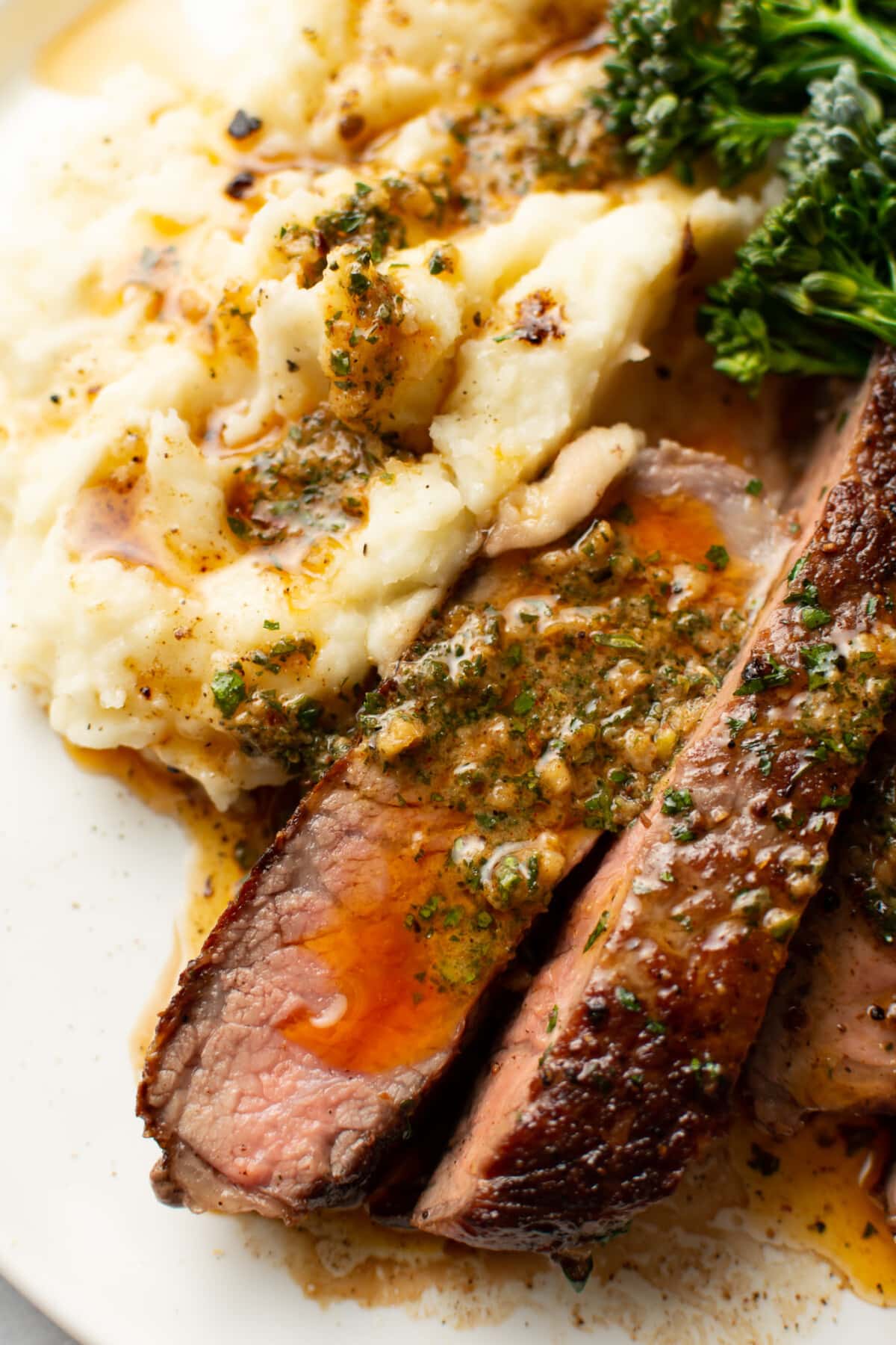 a plate with ribeye steak and cowboy butter along with mashed potatoes