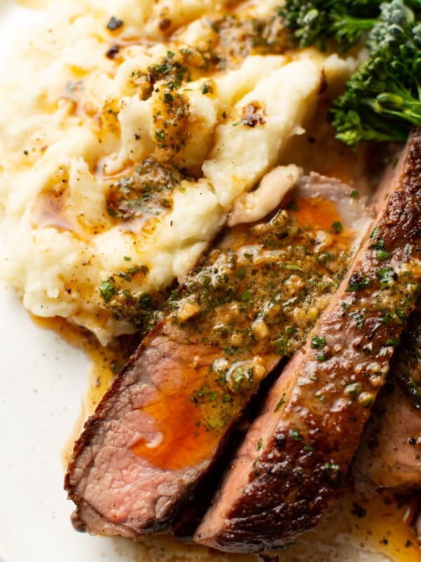 a plate with ribeye steak and cowboy butter along with mashed potatoes